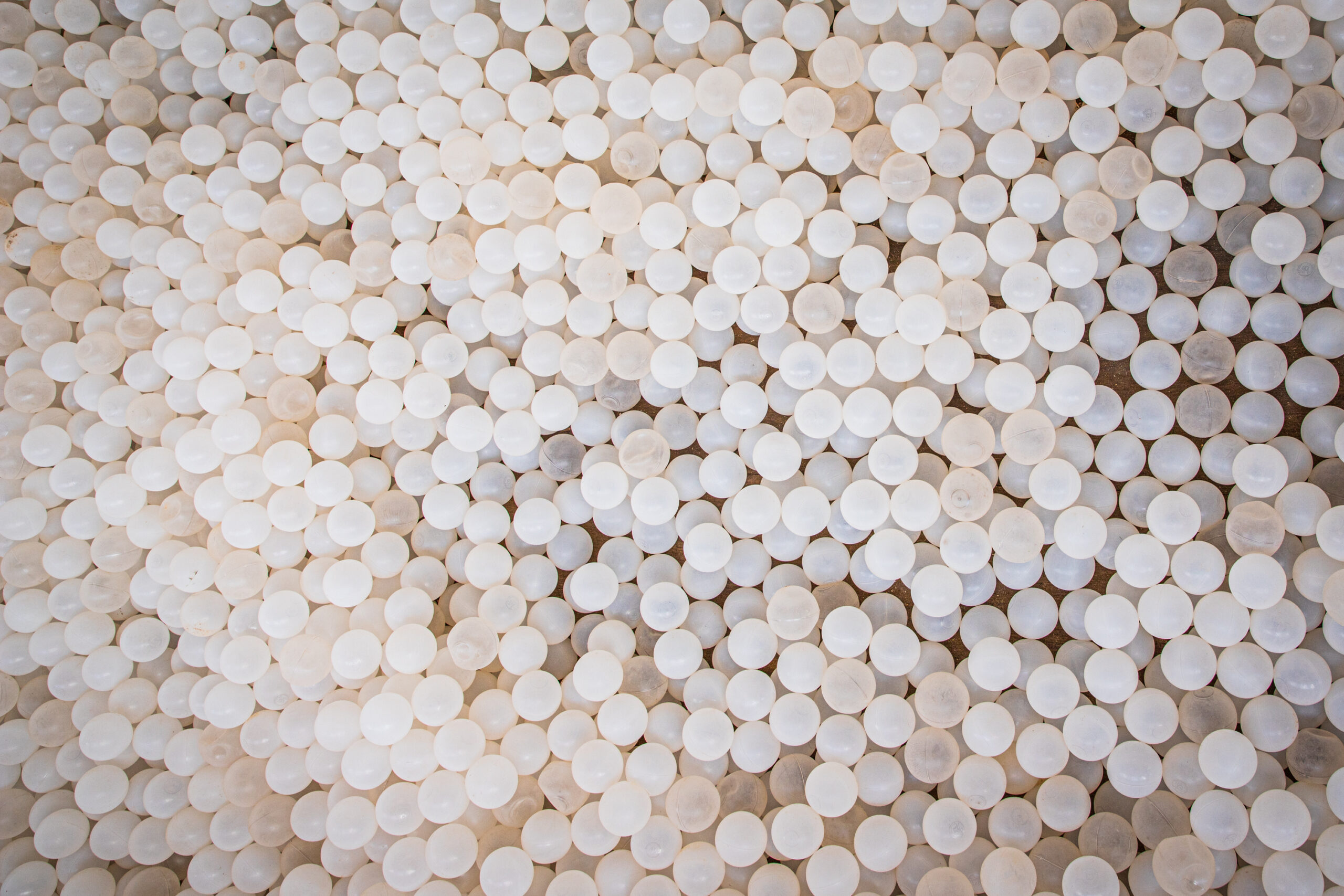 Texture of white plastic balls, top view photo
